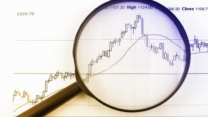 Trader analyzing Forex market on computer screens for long-term investments